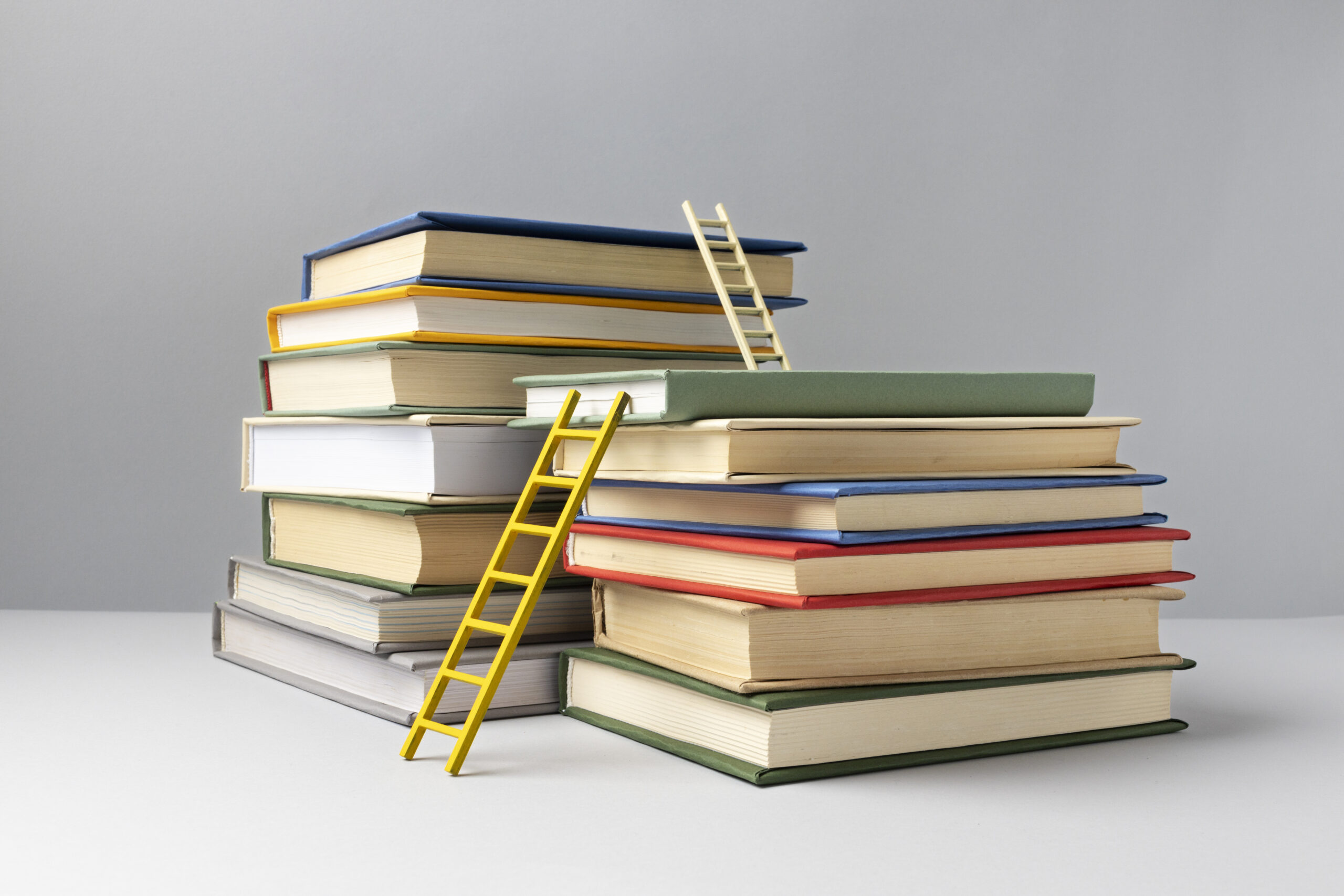 front-view-stacked-books-ladders-education-day-scaled